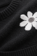Black sweater with a white embroidered flower detail