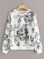 Floral-patterned sweatshirt on a hanger against a gray background