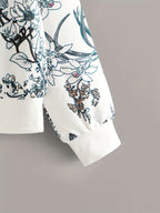 Floral patterned sweater sleeve on a gray background
