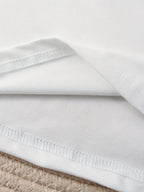 Close-up of a white fabric with a textured edge on a neutral background