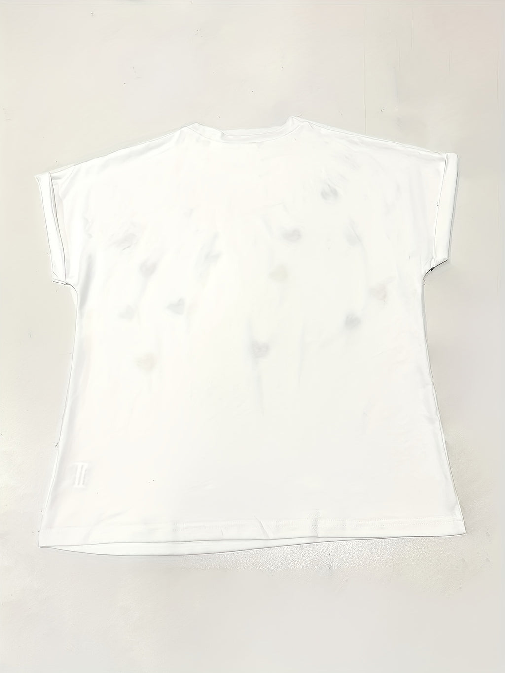 White t-shirt on a light beige background