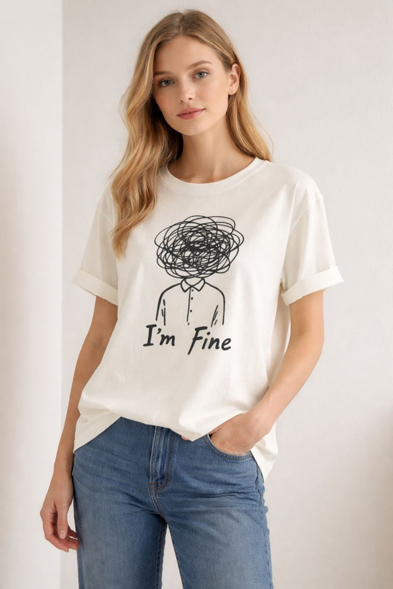 Woman wearing a white t-shirt with a graphic and text 'I'm Fine' on a plain background