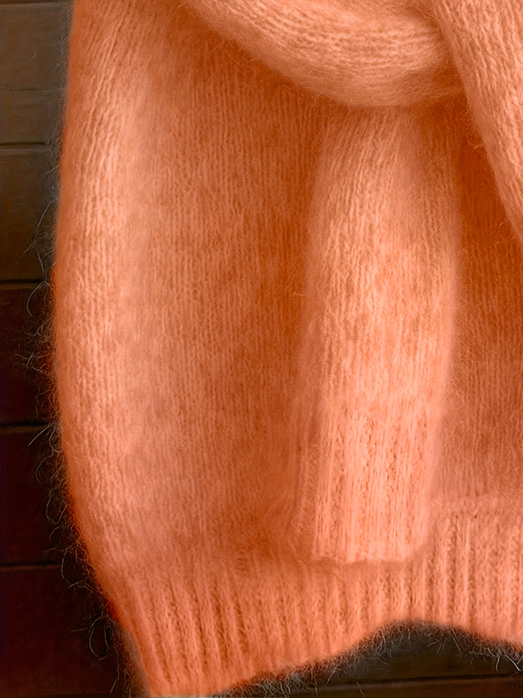 Close-up of a textured orange fabric with a blurred background