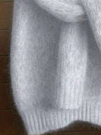 Close-up of gray yarn on a wooden surface
