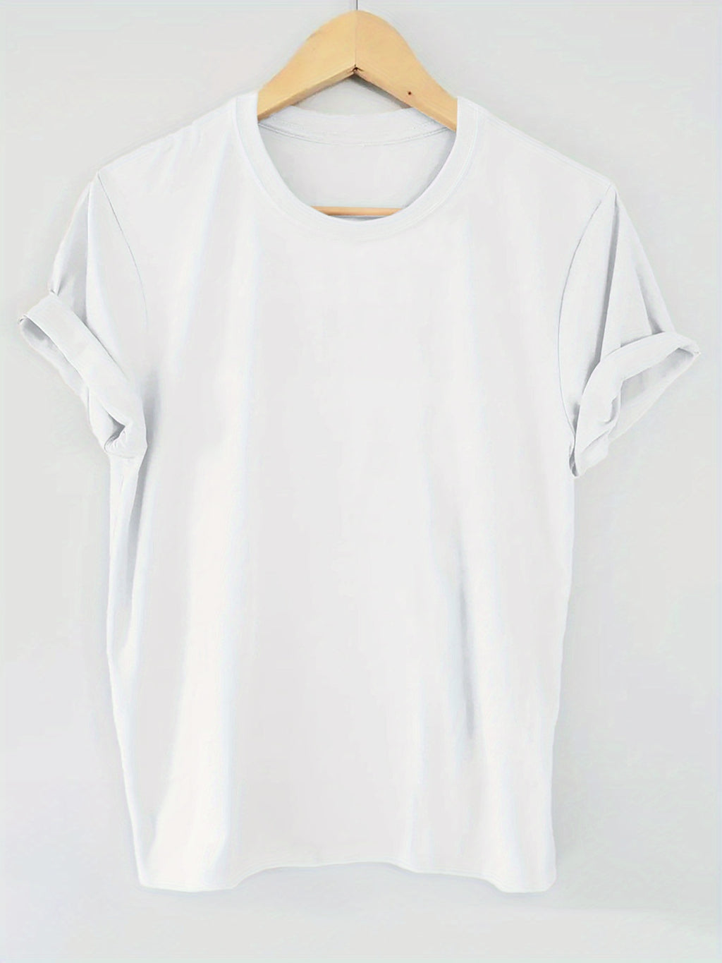 White blouse on a wooden hanger against a white background