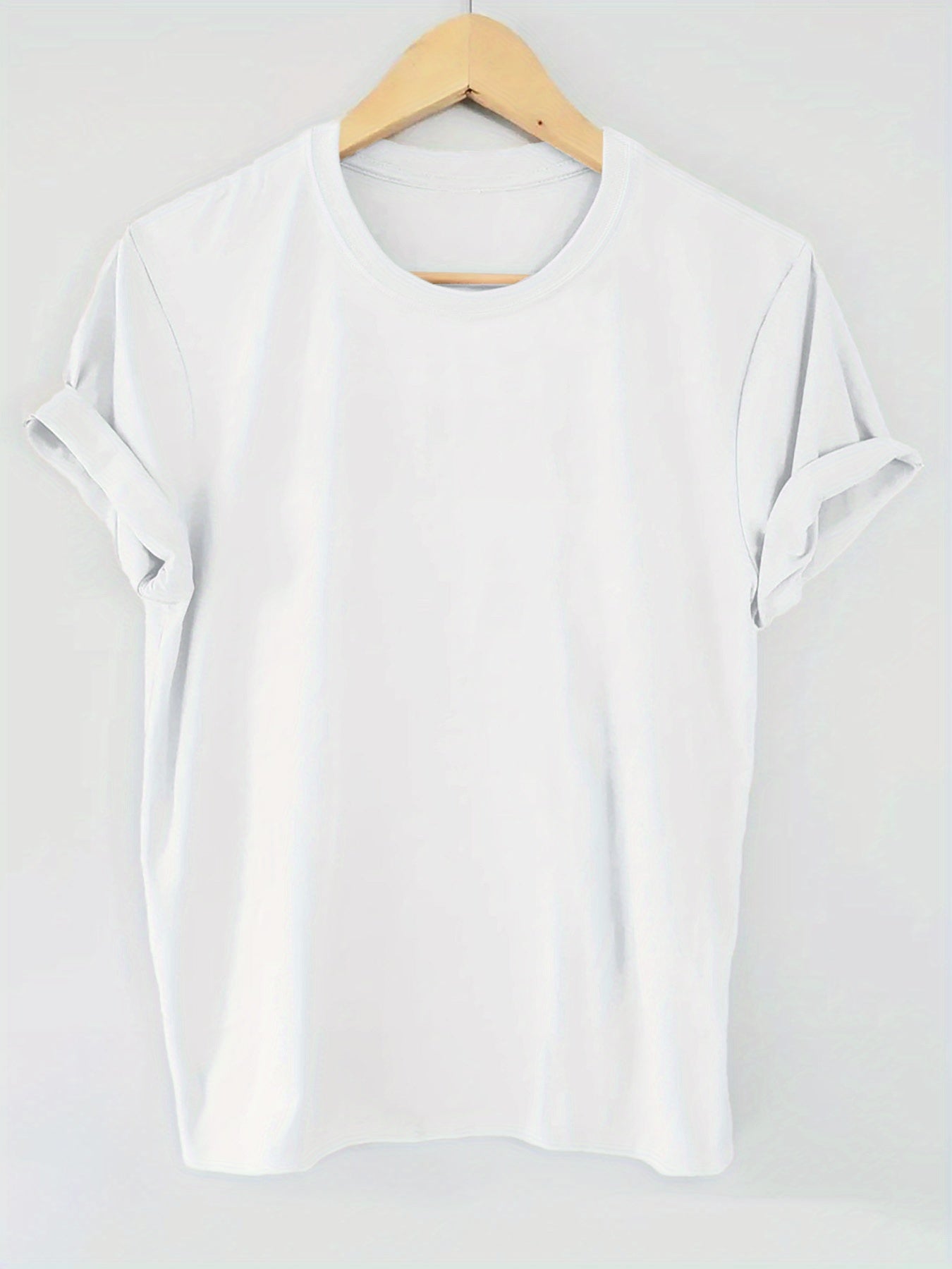 White blouse on a wooden hanger against a white background