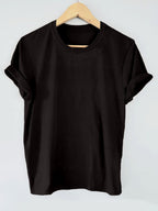 Black t-shirt on a wooden hanger against a light gray background