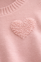 Pink sweater with a heart-shaped pom-pom detail