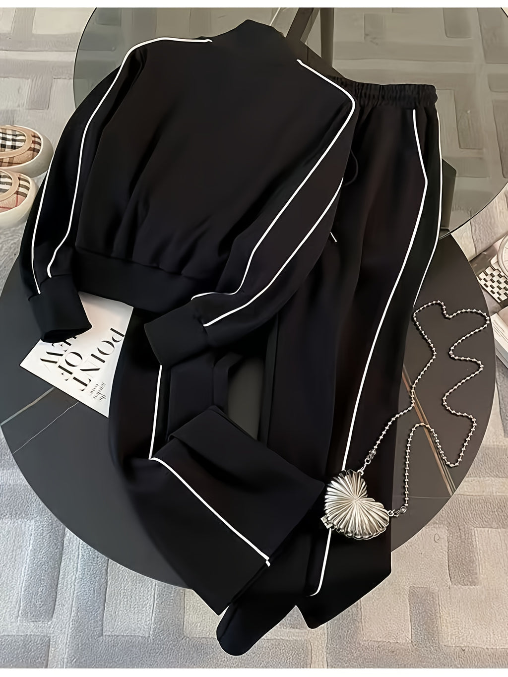 Black outfit with white piping on a round table