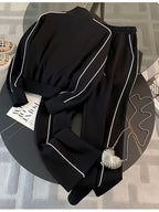 Black outfit with white piping on a round table