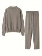 Beige sweater and pants set on a white background
