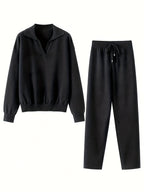 Black sweater and pants set on a white background