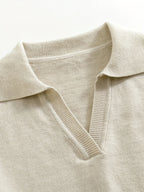 Close-up of a beige sweater with a collar on a white background