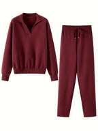 Maroon hoodie and pants set on a white background