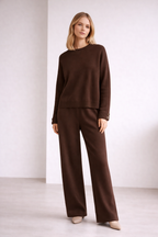 Woman wearing a brown outfit against a white background