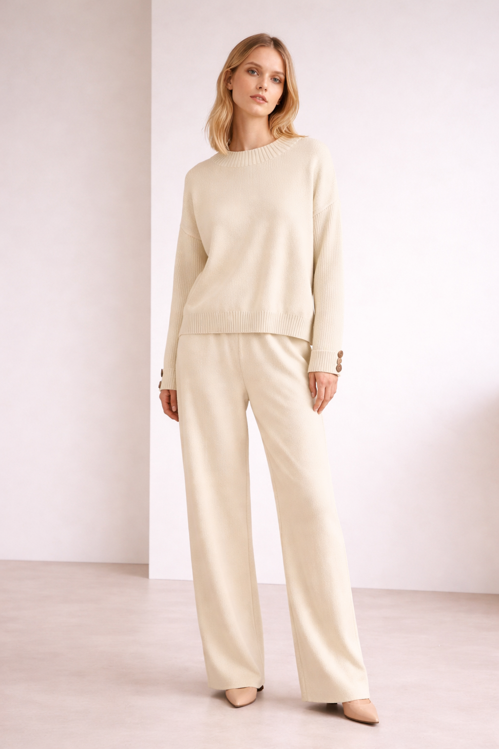 Woman wearing a beige outfit against a white background