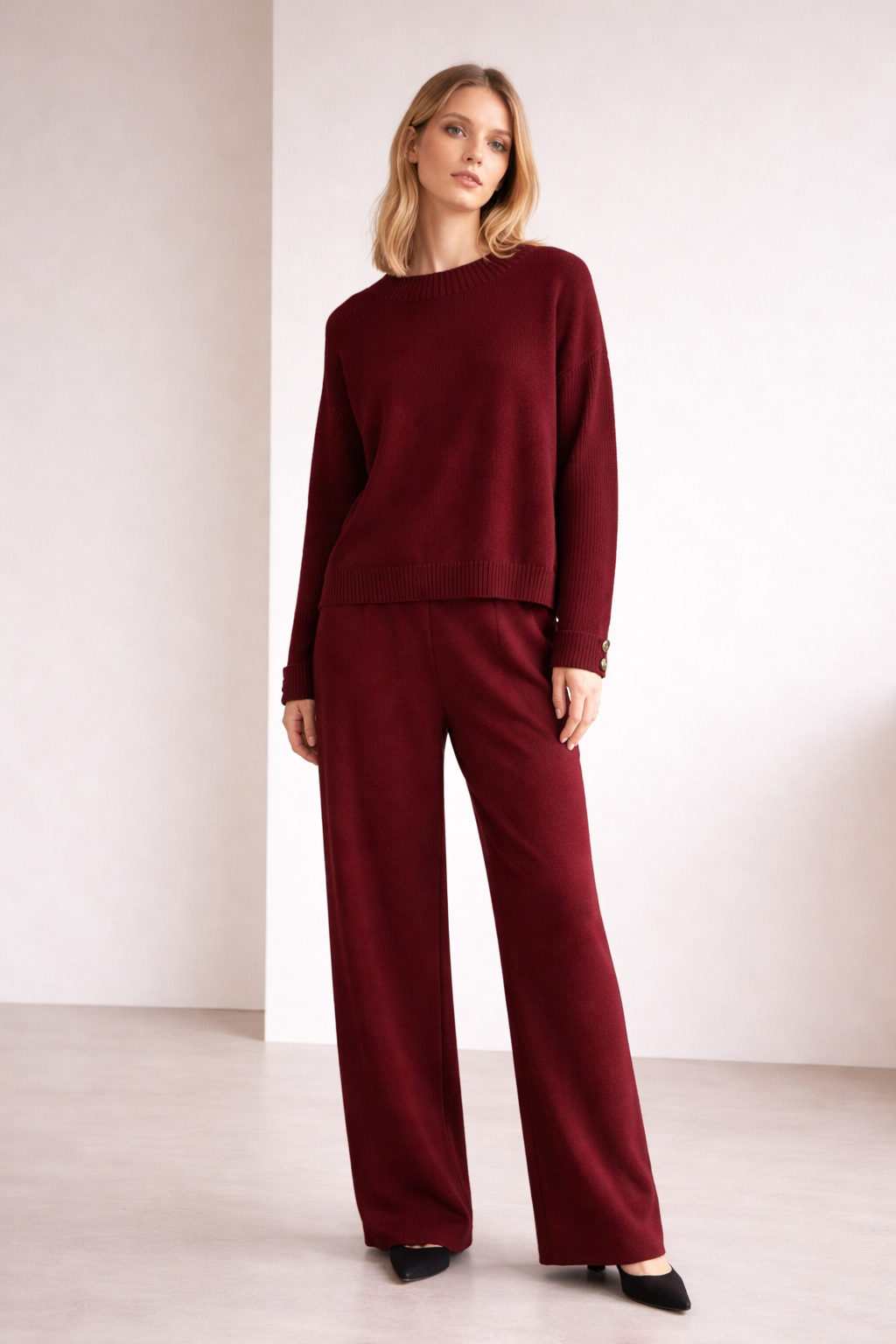 Woman wearing a burgundy outfit against a white background