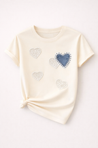 Beige t-shirt with heart designs on a white background