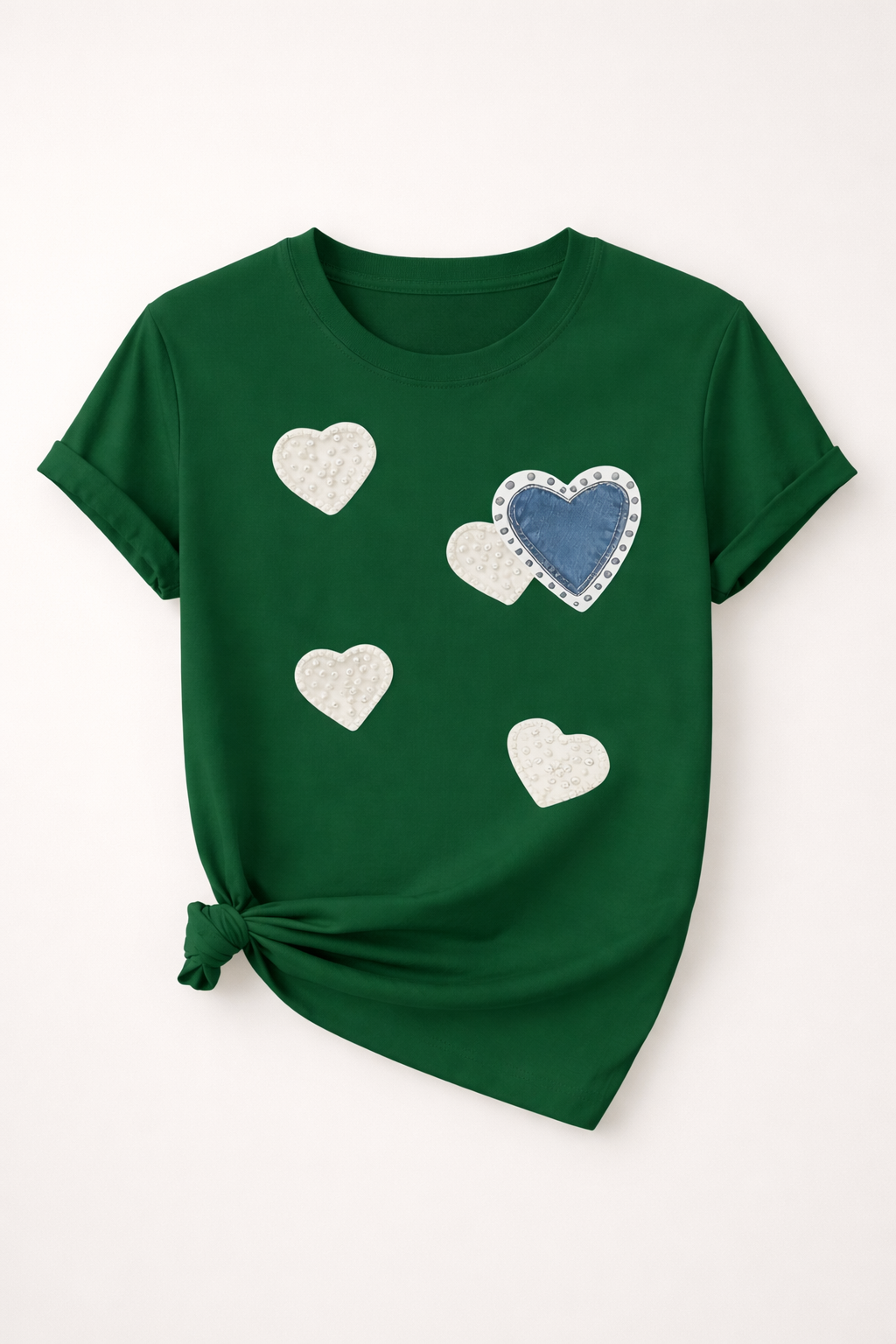 Green t-shirt with heart designs on a white background