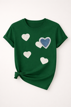 Green t-shirt with heart designs on a white background