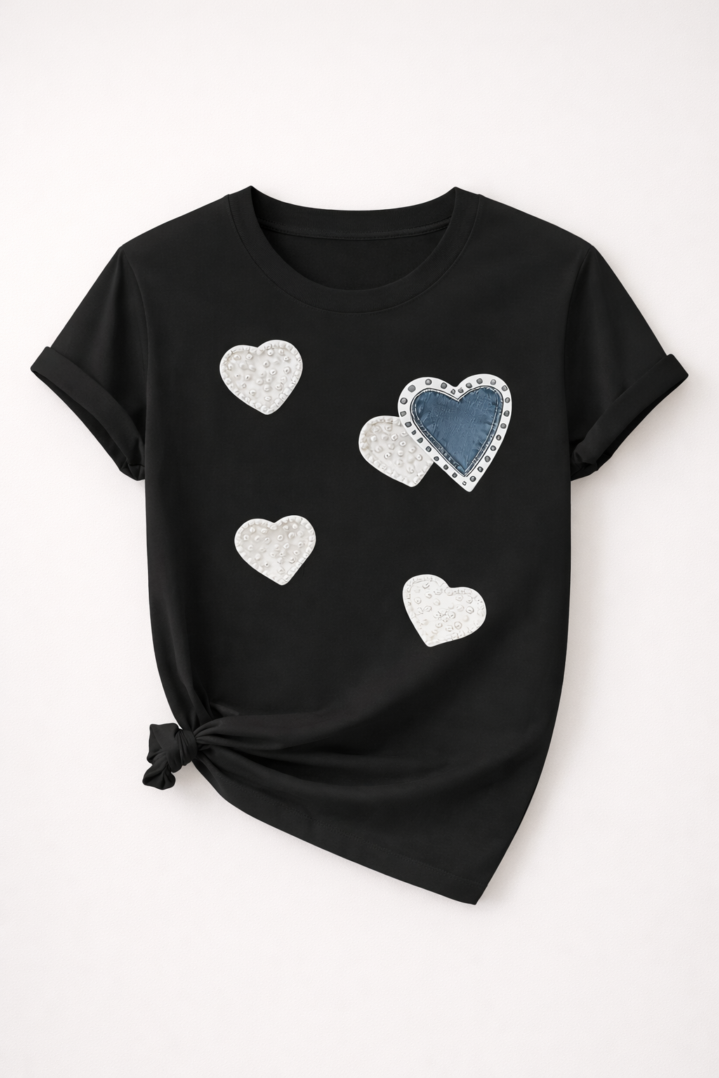 Black t-shirt with heart-shaped designs on a white background