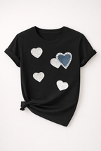 Black t-shirt with heart-shaped designs on a white background