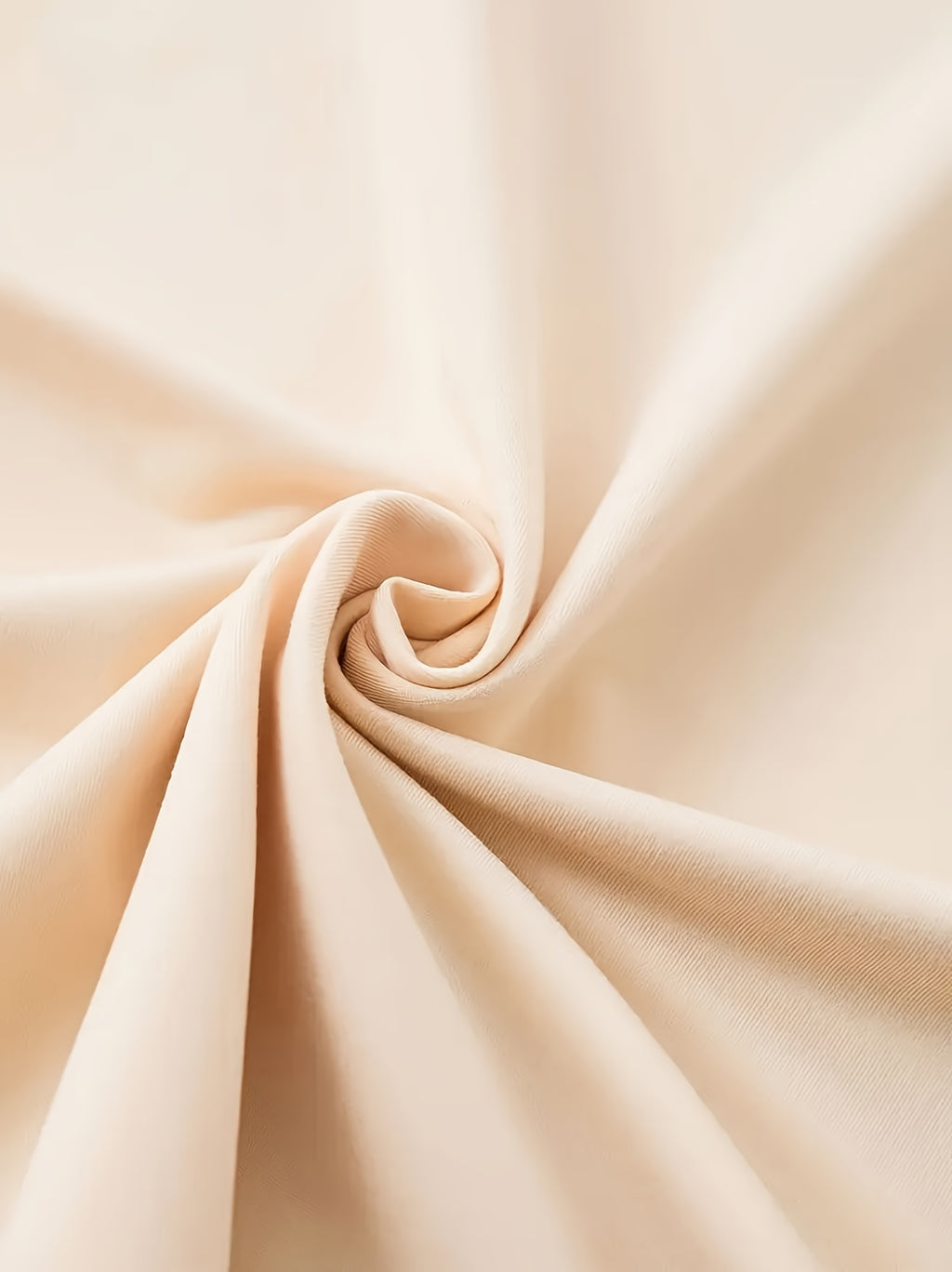 Beige fabric with a swirl pattern on a light beige background