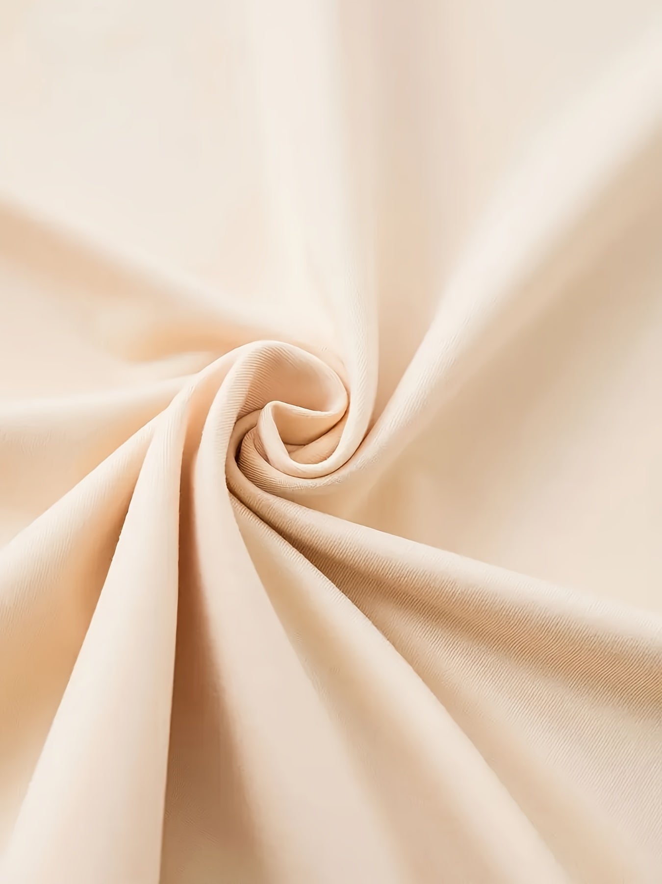 Beige fabric with a swirl pattern on a light beige background