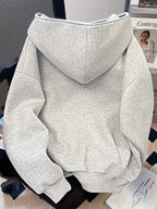 Gray hoodie on a chair with a magazine in the background