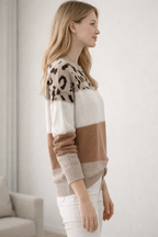 Woman wearing a patterned sweater with a neutral background