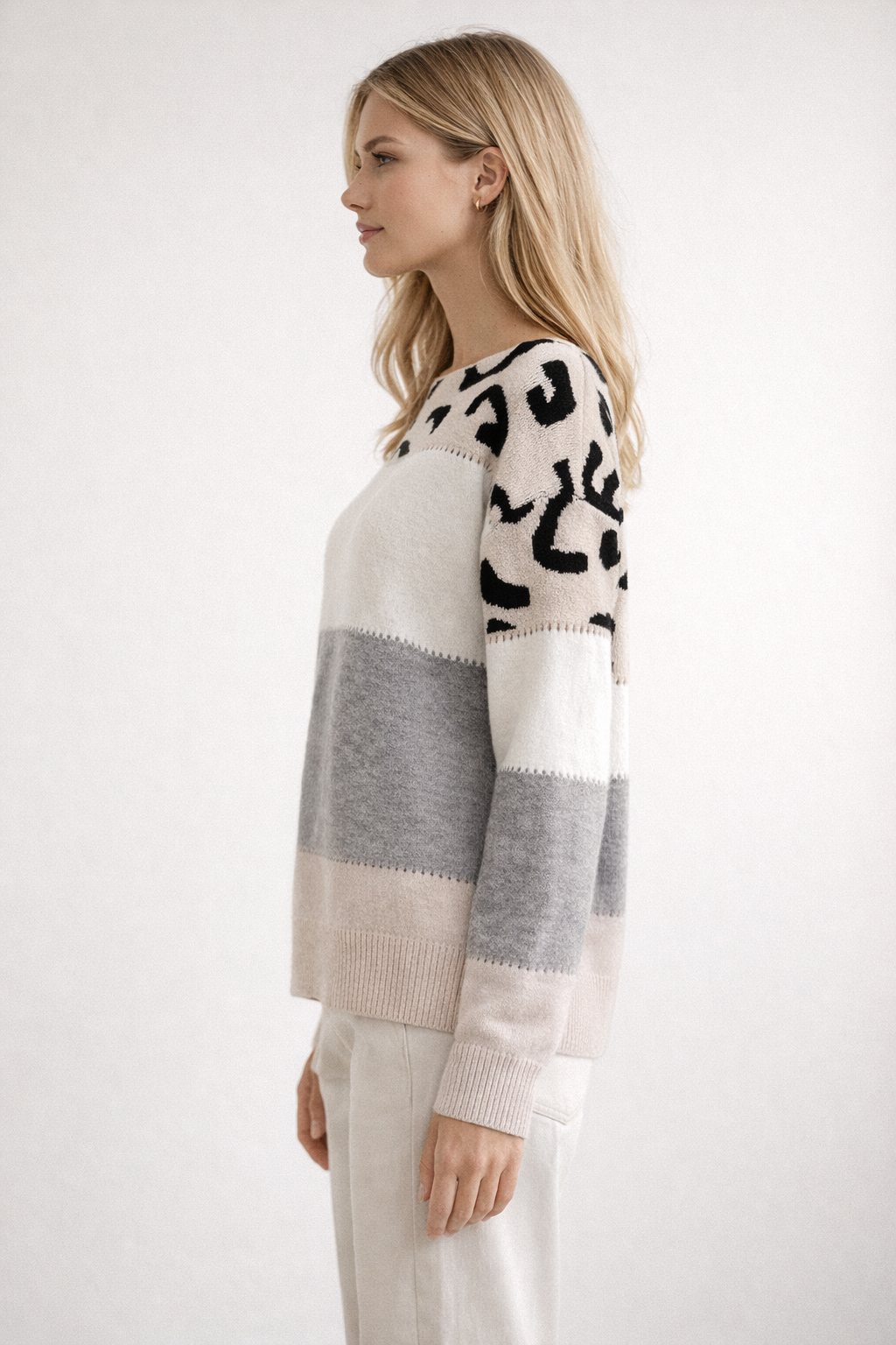 Woman wearing a patterned sweater with a white background