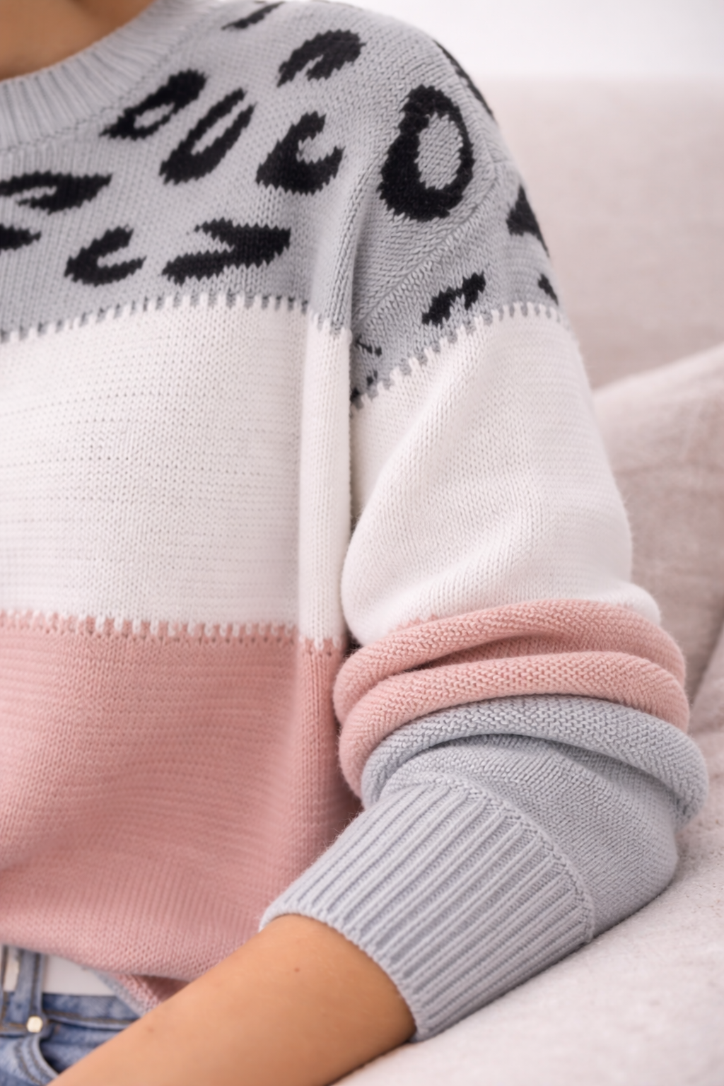 Close-up of a sweater with leopard print pattern on a light background