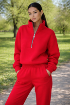 Person wearing a red tracksuit in a park setting